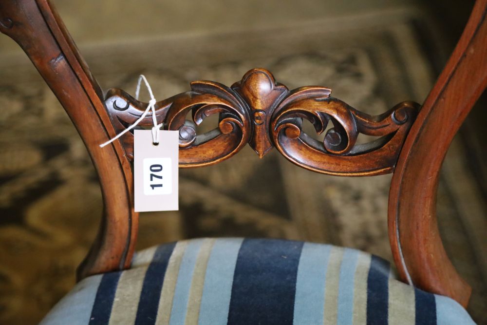 A set of four Victorian walnut balloon-back chairs